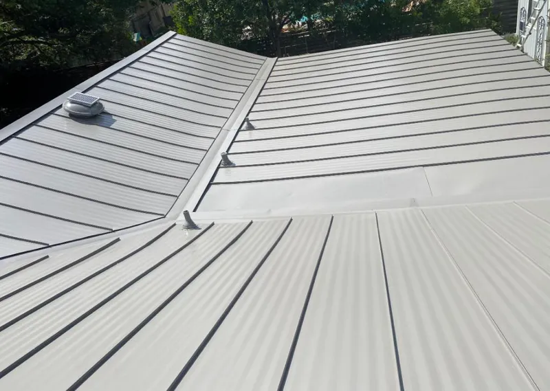 Solar attic fan installed on a metal roof for Roof Ventilation in Evansville